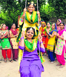 Girls enjoy swing during a function organised to celebrate Teej at Mehta Enclave in Bathinda on Sunday.