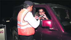 A policeman conducts alcohol sensor test on a commuter during The Night City Seal Plan operation in Chandigarh on Saturday.