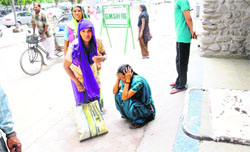 A patient waits for a wheelchair at the entry point to the GMSH, Sector 16, Chandigarh