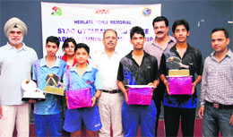 The winners of a table tennis championship in Dehradun on Sunday. 