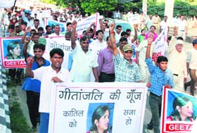 People hold a protest march, seeking justice for Geetanjali Garg, in Gurgaon on Sunday