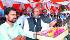 PDP leader Muzaffar Hussain Baig speaks at a rally in Rajouri on Sunday. 