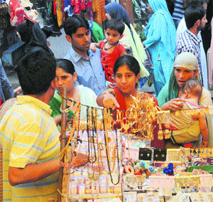  Women throng markets ahead of the Eid-ul-Fitr in Srinagar on Sunday. 
