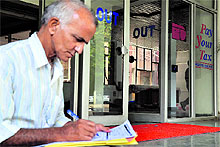 A man fills out an income tax return form in Ludhiana on Sunday