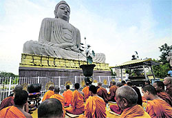 Monks offer prayers for peace in front of Lord Buddhas statue in Bodh Gaya on Sunday