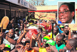 Members of Mugabes party celebrate his win by carrying a coffin draped in a flag of Opposition party Movement for Democratic Change in Mbare on Sunday.