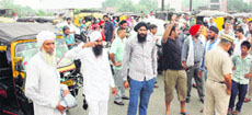 The kin of the jail inmate who died due to illness on Sunday night block the Bhandari bridge in Amritsar on Monday.