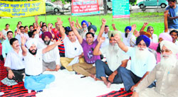 Members of the Punjab State Aided School Teachers & Other Employees Union protest in Amritsar on Monday.
