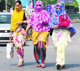 Beat the heat: Women cover their faces to escape the heat in Bathinda on Monday