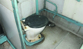 A dirty washroom in one of the compartments.