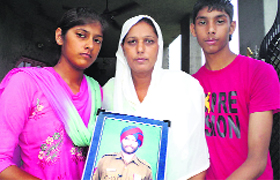 Kashmir Kaur (centre), wife of Kashmir Singh, with her children.