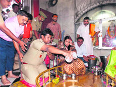 On the successful completion of the Kanwar fair, DM Nidhi Pandey and SSP Rajeev Swarup offer Ganga jal at the Daksheswar Mahadev temple in Haridwar on Monday.