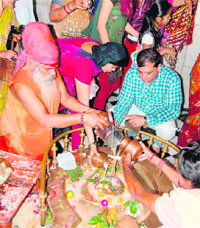 Devotees offer Ganga jal and milk at a Kankhal temple in Haridwar on Monday. 