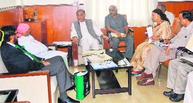 Chief Minister Vijay Bahuguna holds talks with Dr RK Pachauri, Director General of TERI, and Dr Anil Joshi of the Himalayan Environmental Studies and Conservation Organisation on the issue of gross environment product in Dehradun on Monday.