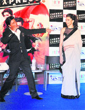 Bollywood actors Shahrukh Khan and Deepika Padukone promote their movie Chennnai Express during an event in Gurgaon.