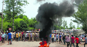 Protesters block the Jammu-Srinagar Highway in Jammu on Monday.