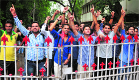 Students of GGM Science College stage a protest against the college administration at the main gate of the institute in Jammu on Monday.