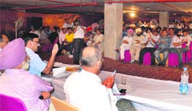 GLADA Estate Officer RK Popli (in blue shirt) conducts an auction of residential plots and commercial sites in Ludhiana on Monday
