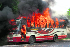 A file photo of a bus, allegedly set on fire by demonstrating Jamaat-e-Islami activists, near Dhaka. 