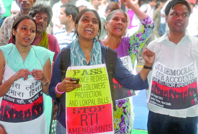RTI activists shout slogans during a protest near Parliament against the changes in the RTI Act, in New Delhi on Tuesday. 