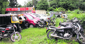 Vehicles gather dust at the Dalanwala police station in Dehradun on Tuesday.