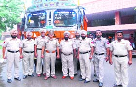 Policemen along with the impounded truck from which poppy husk was seized