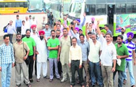 Employees of the Punjab Roadways stage a protest outside the bus stand in Jalandhar on Tuesday