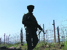 A BSF jawan guards the border at the Line of Control in Poonch.