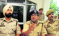 Senior police officials address mediapersons at the Nawabad police station in Jammu on Tuesday