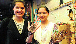 Girls paint their hands with henna ahead of Eid-ul-Fitr in Srinagar on Tuesday