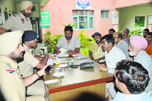 Police officers listen to residents grievances at the Kotwali police station in Ludhiana on Tuesday. 