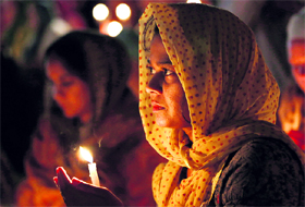 Mourners attend a candlelight vigil on the first anniversary of a mass shooting at a US gurdwara, in Oak Creek, Wisconsin, on Tuesday.