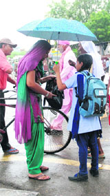 A girl offers the protection of an umbrella to a woman to save her from the showers in Bathinda on Tuesday.
