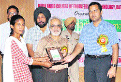 BFGI chairman Gurmeet Singh Dhaliwal and  KK Yadav, DC, give away prize to a student in Bathinda on Wednesday. 