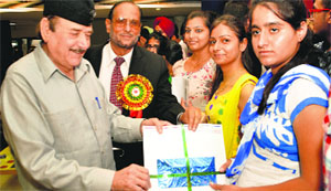 Lt Gen BKN Chhibber (retd) hands over documents related to study visas to a student in Fatehgarh Sahib.