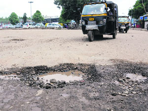 Potholes on the road are a common sight.