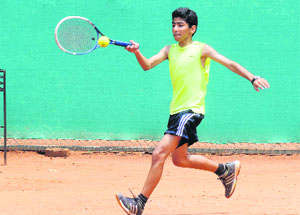 Sehaj Punj returns a shot during the Total Tennis AITA Tournament at The British School, Sector 70, in Mohali on Wednesday.