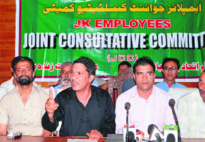 Joint Consultative Committee leader and Employees Joint Action Committee president Abdul Qayoom Wani addresses a press meet in Srinagar on Wednesday. 