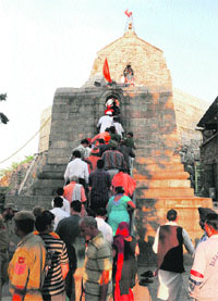 Devotees queue up for prayers at the Sankaracharya Temple in Srinagar on Wednesday.