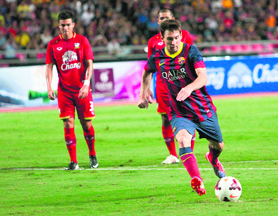 Barcelona's Lionel Messi scores from the penalty spot against Thailand during their friendly at the Rajamangala Stadium in Bangkok on Wednesday. 