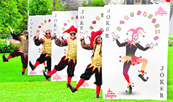 Black Jesters from the London Dungeon pose for pictures with a set of what the attraction describes as the world's biggest playing cards, in London, on Wednesday.  AFP