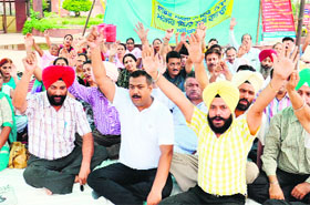 Members of the Punjab State Aided School Teachers Union protest against the state government at Bhandari Bridge in Amritsar on Thursday.