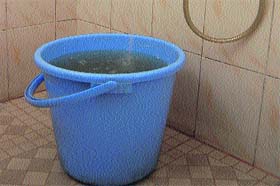 Muddy water flows through a tap in Hamirpur