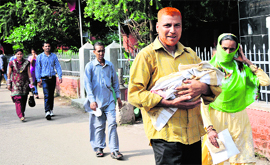 A couple with their newborn outside the SGMS Hospital in Jammu.