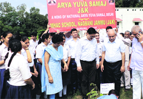 Students and staff of MHAC School plant saplings on the first day of Vanmahotsava Week at Nagbani In Jammu on Thursday.