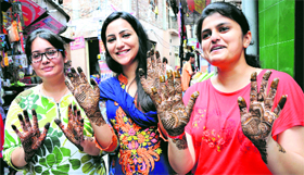 Girls with beautiful henna patterns on their palms on the eve of Eid-ul-Fitr in Jammu on Thursday.
