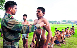 An official measures the chest of a candidate during a recruitment rally at the Dholewal Military Complex in Ludhiana on Thursday.