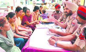 Police officers listen to residents grievances at the Division No. 6 police station in Ludhiana on Thursday. 
