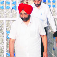 Accused District Transport Officer BM Singh being taken away by the police after being produced in court in Bathinda on Thursday. 