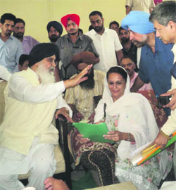 Chief Minister Parkash Singh Badal listens to the demands of Congress Muktsar MLA Karan Kaur Brar at Bhalaiana village in Gidderbaha on Thursday. 